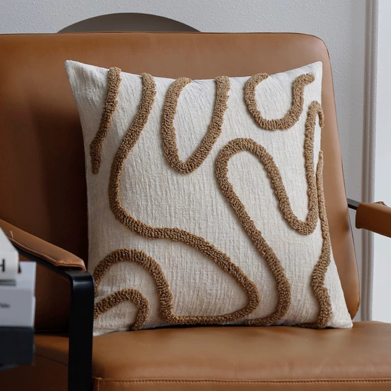 Decorative pillow with brown patterns on a brown chair