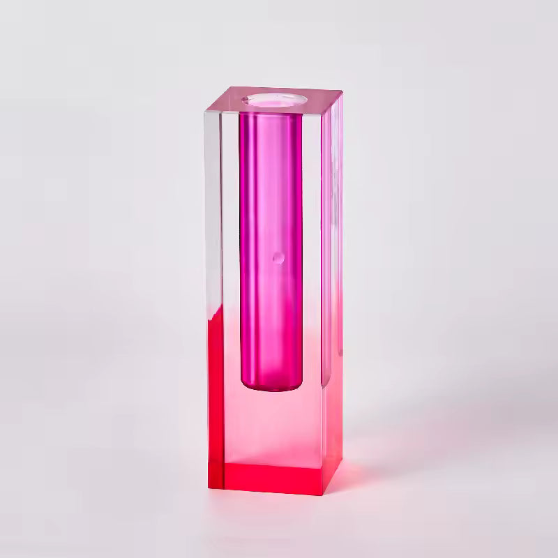 Pink cylindrical object with a clear rectangular base on a white background