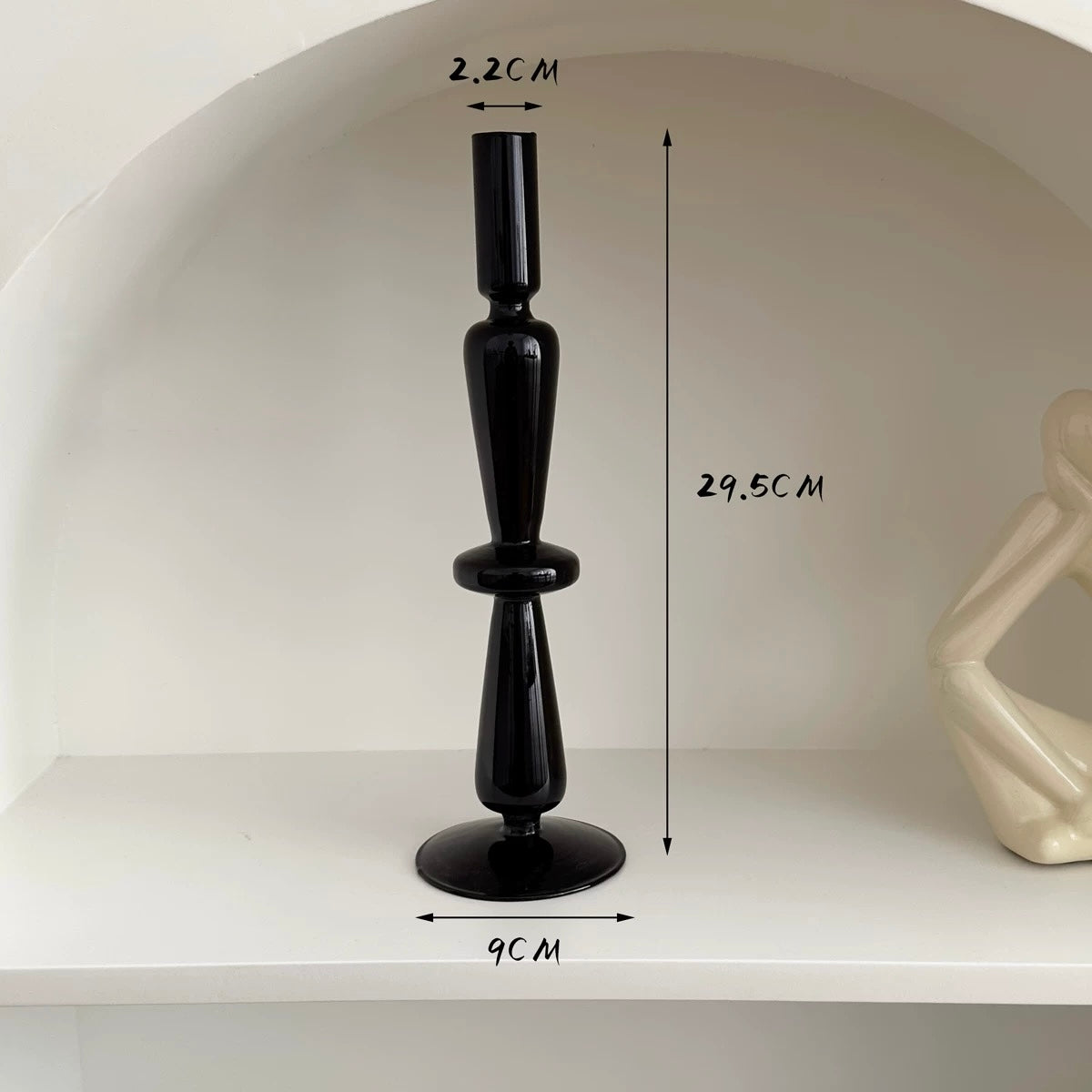 Black candlestick with measurements on a white background