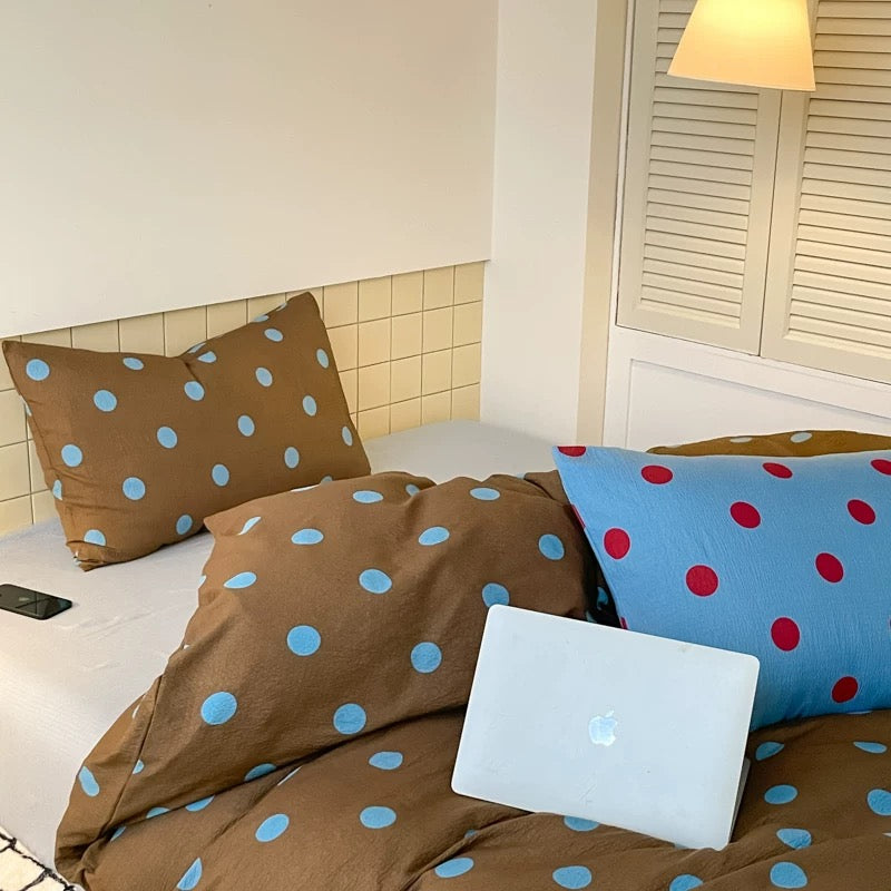 Brown blue polka dot bedding styled for neutral preppy teen bedroom aesthetic
