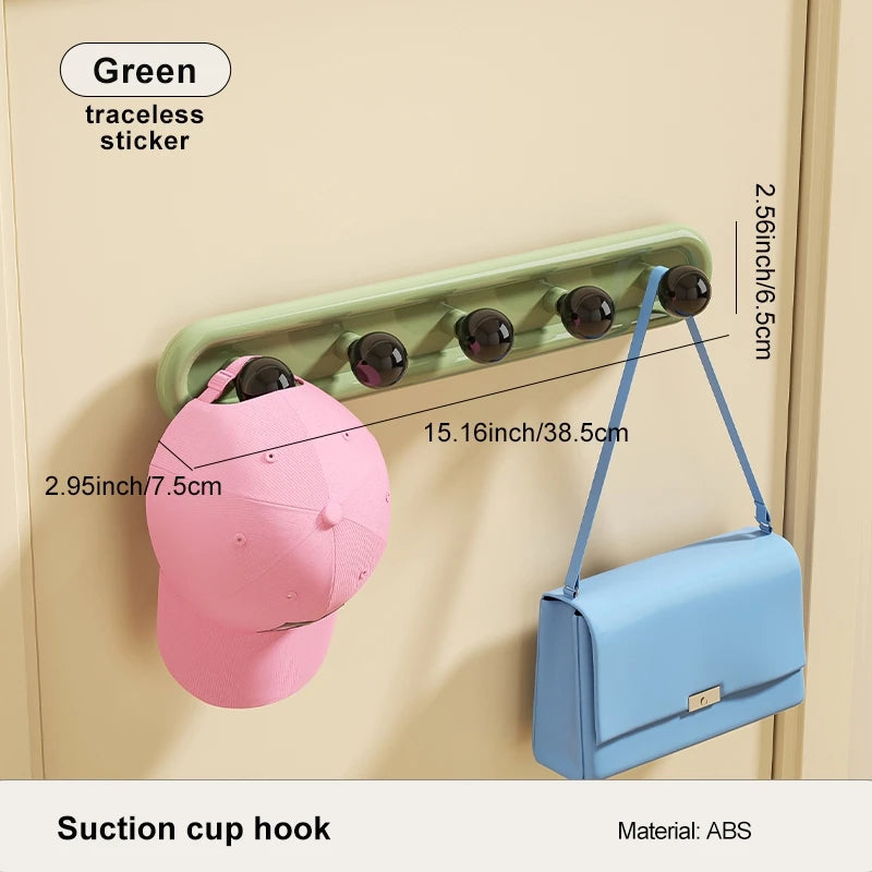 Suction cup hook with a pink cap and blue bag attached, showing dimensions on a beige background.