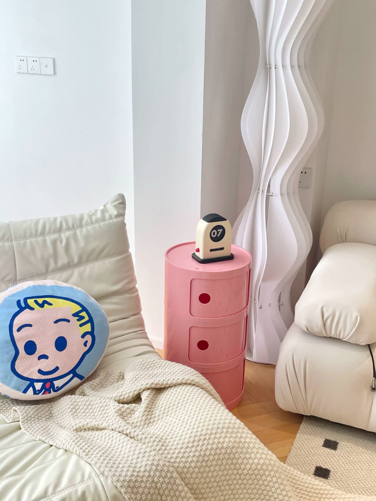 Pink bedside table with drawers for bedroom organization