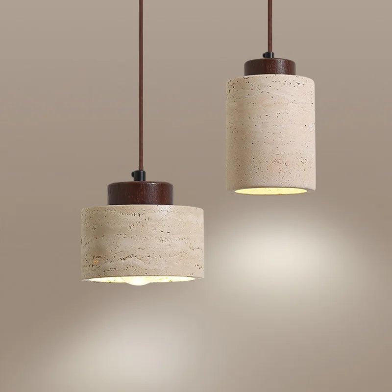 Nordic cylinder pendant light with textured beige shade and warm ambient lighting for dining area.