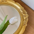 Antique-inspired vanity tray with ornate gold handles