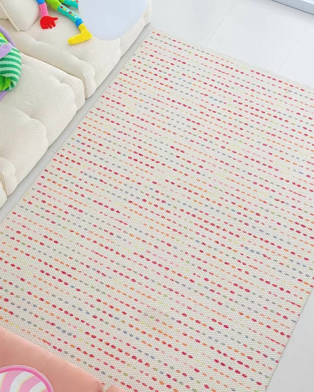 Baby play mat with colorful toys on a white surface