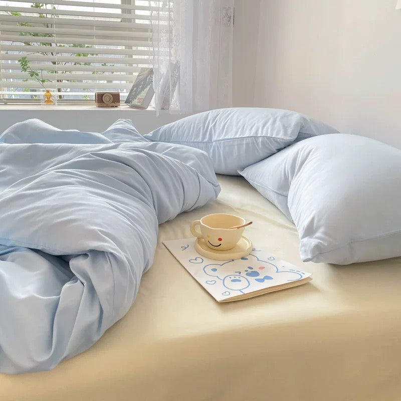 Korean minimalist cream blue duvet cover set styled in bright natural light.