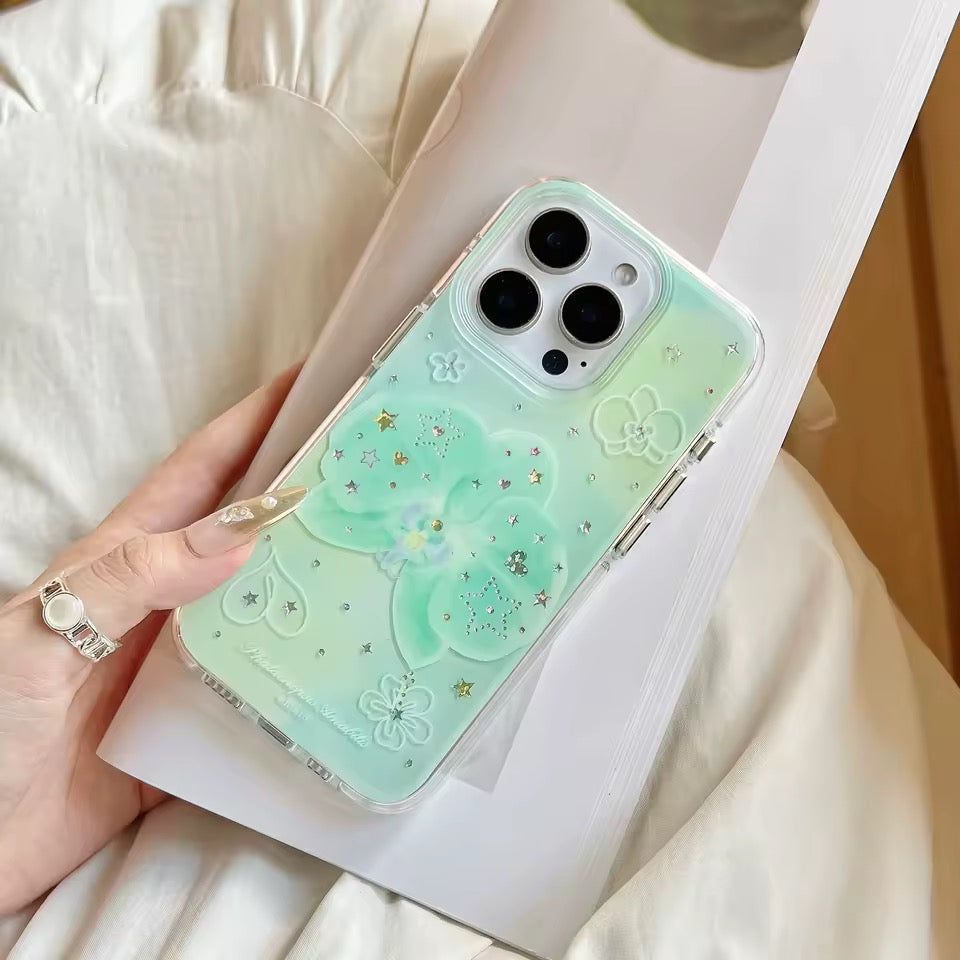 Phone case with floral design held by a hand on a light background