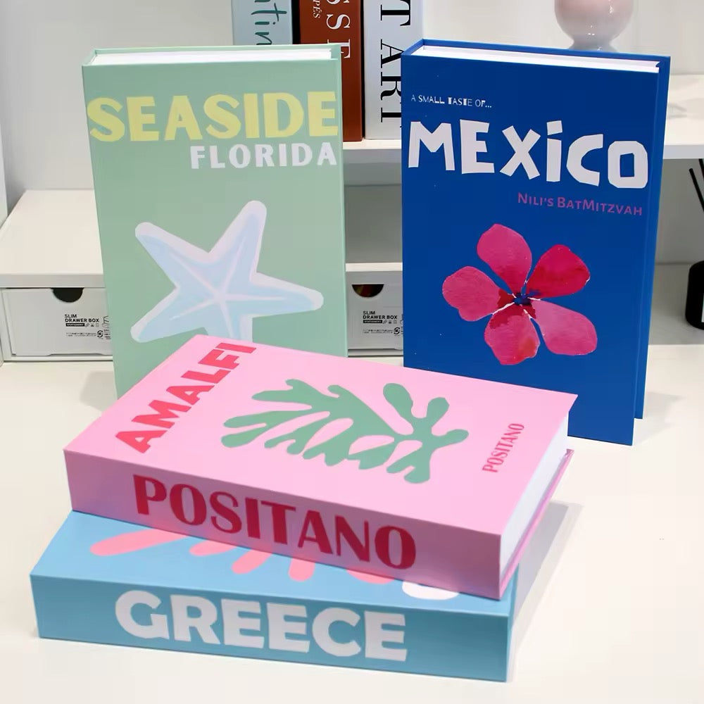 Pink and turquoise Miami Beach book box laying flat on a table, styled next to a yellow Palm Beach box.