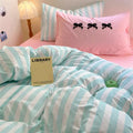 Pastel stripe duvet cover with charming pink accents in a cozy dorm room setup