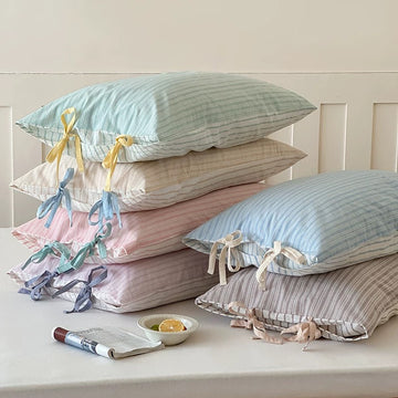 Pastel striped bow pillow cases in soft cotton, perfect for aesthetic bedrooms.