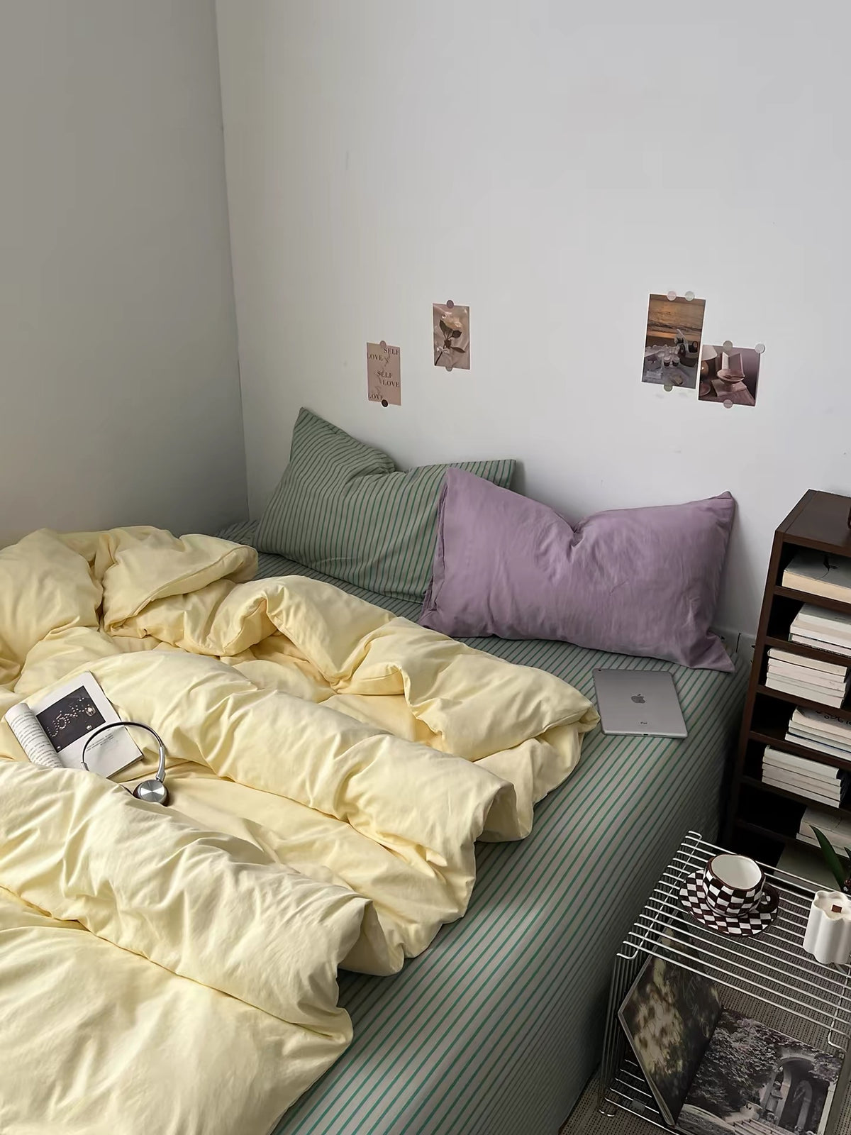 Yellow sage bedding set viewed from the foot of the bed with pastel pillows