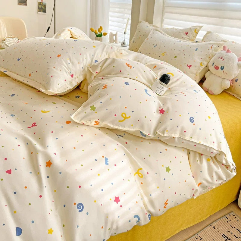 Folded pastel dotted comforter showing smooth polyester microfiber texture.