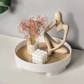 Minimalist wooden tray holding perfumes and decorative items.