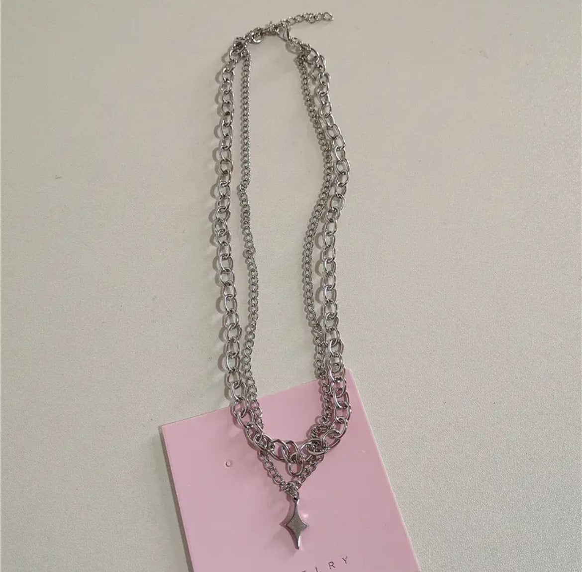 Stylish gothic Y2K necklace with pink beaded chain, featuring strawberry bowknot pendant and cross charms for women’s fashion.