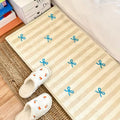 Thick plush rug with striped bow design for kids' room