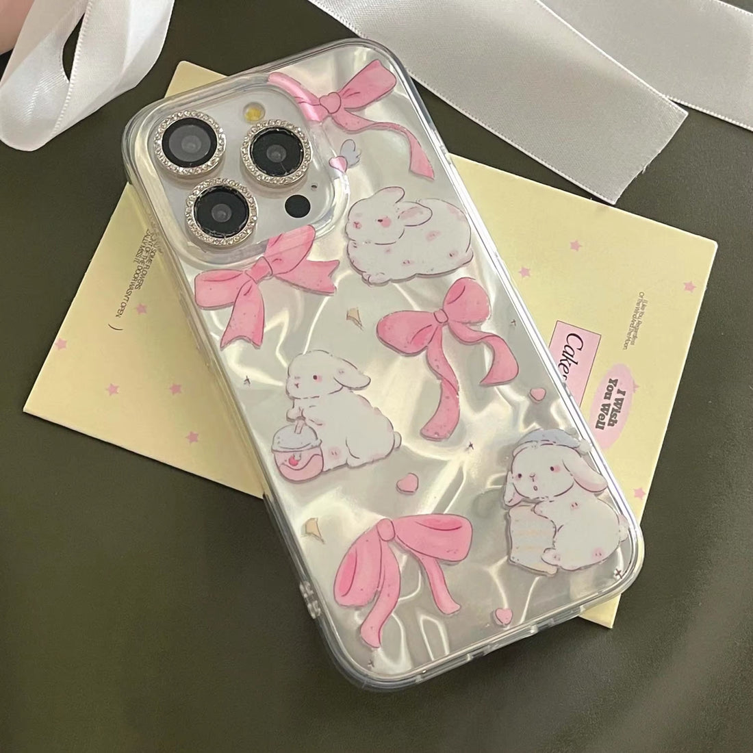 Coquette-inspired pink iPhone case with bunny and stars