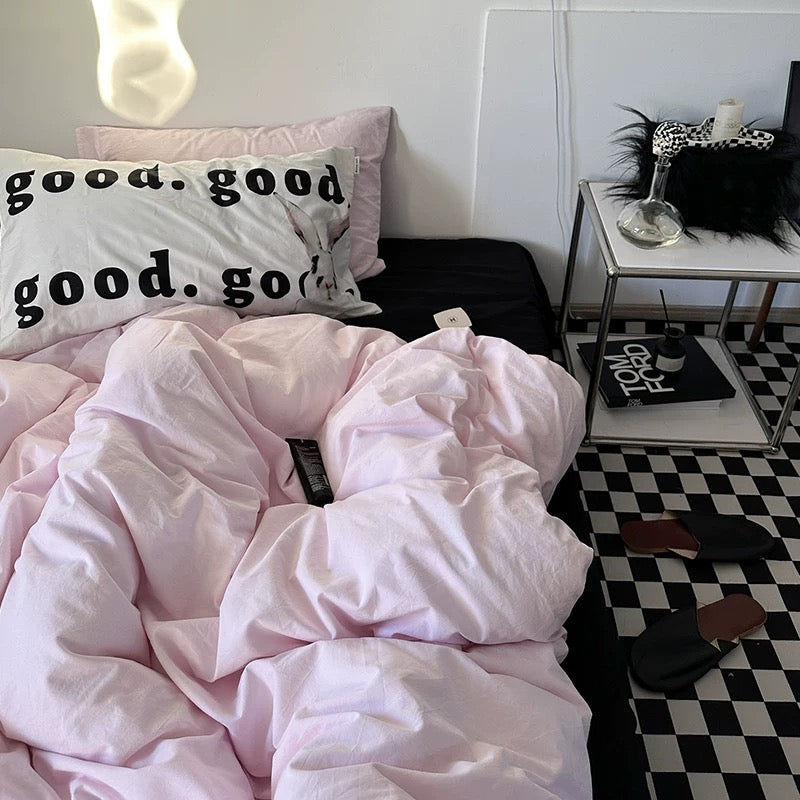 Modern minimalist pink duvet set with black and white decor.