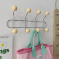 Boho wall hooks in pink, perfect for hanging coats and hats