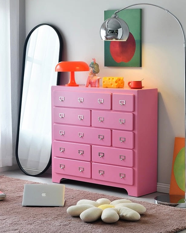 Dopamine pink drawer storage cabinet styled in colorful aesthetic bedroom interior