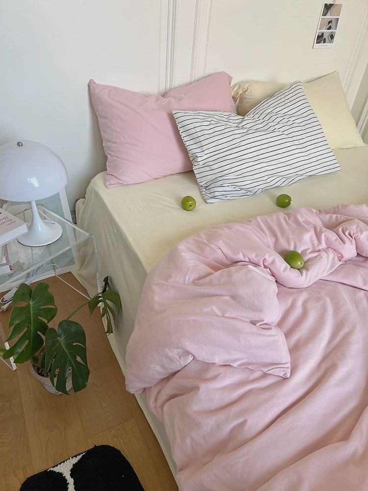 Pale pink jersey knit duvet cover set with cream sheet and contrasting pillowcases