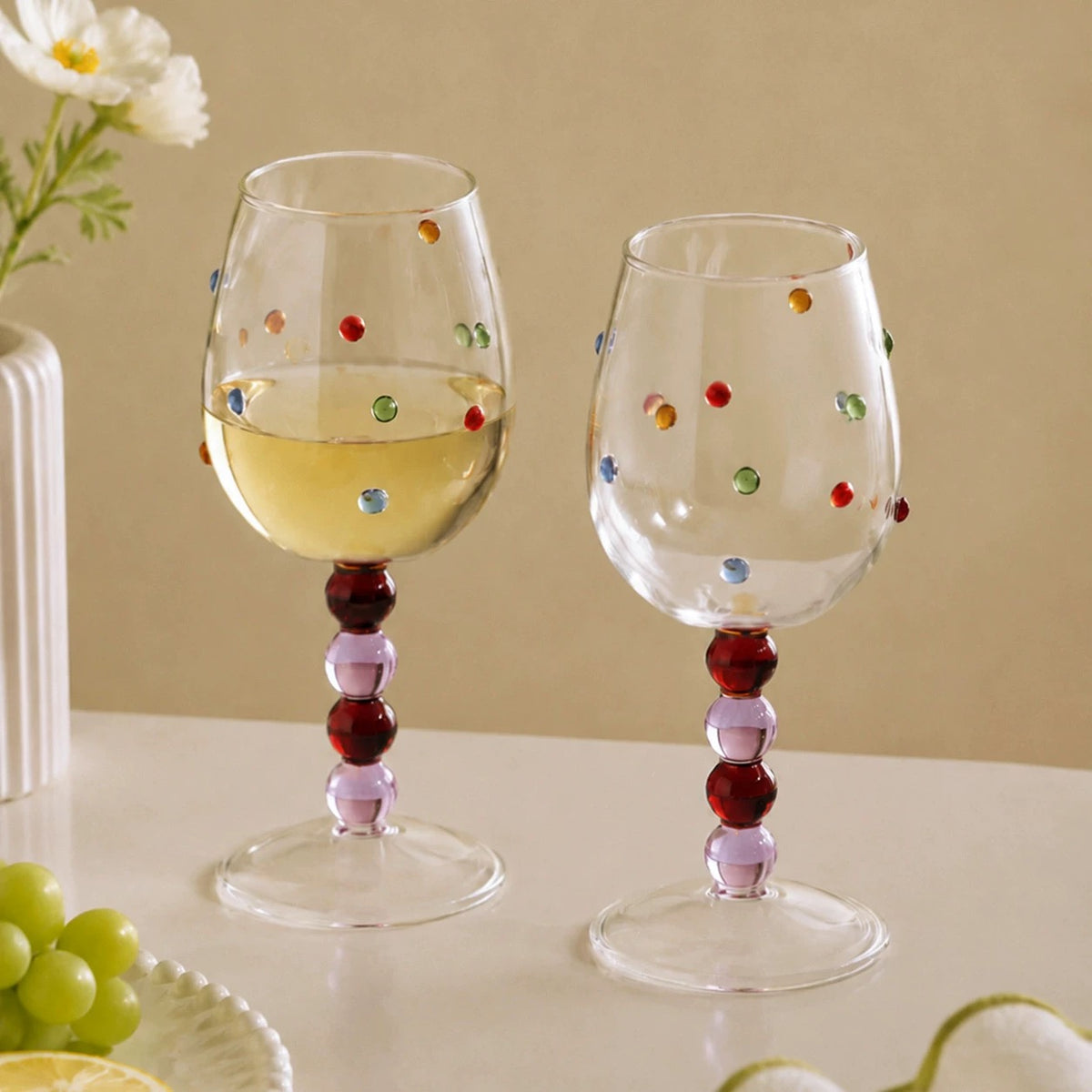 Pink polka dot wine glasses with stacked rounded stems and clear bowls