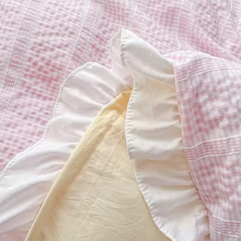 Close-up of soft fabric with a checkered pattern in pink and white.