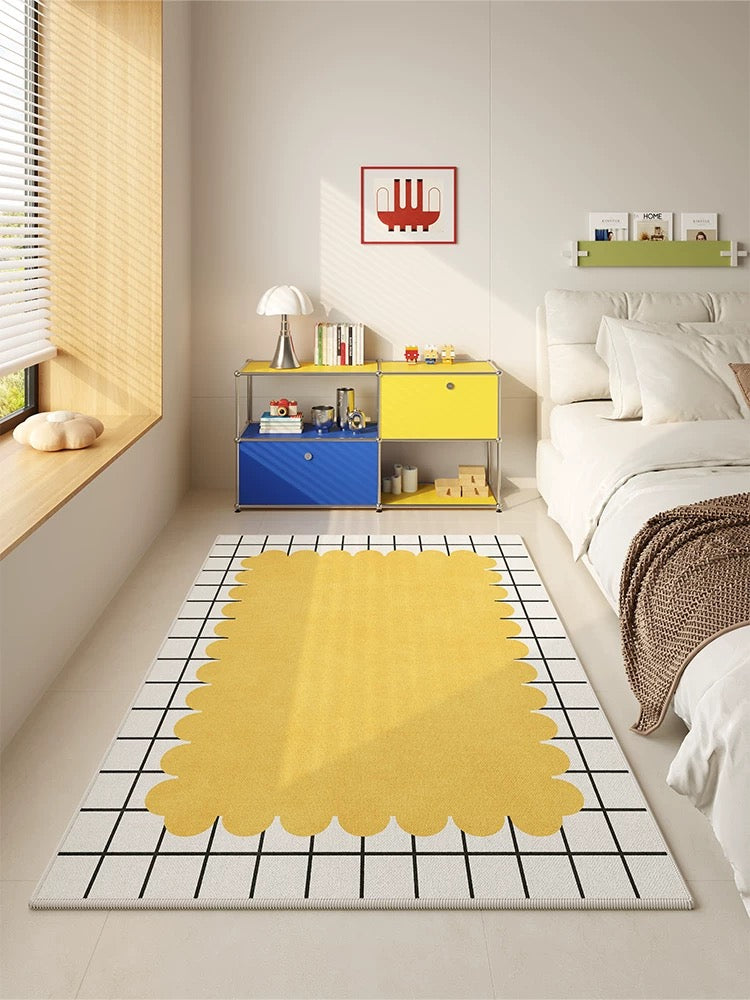 Modern bedroom with a yellow rug, colorful storage unit, and framed artwork.