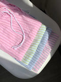 Pink striped cotton pajama pants with a drawstring waist and wide-leg design