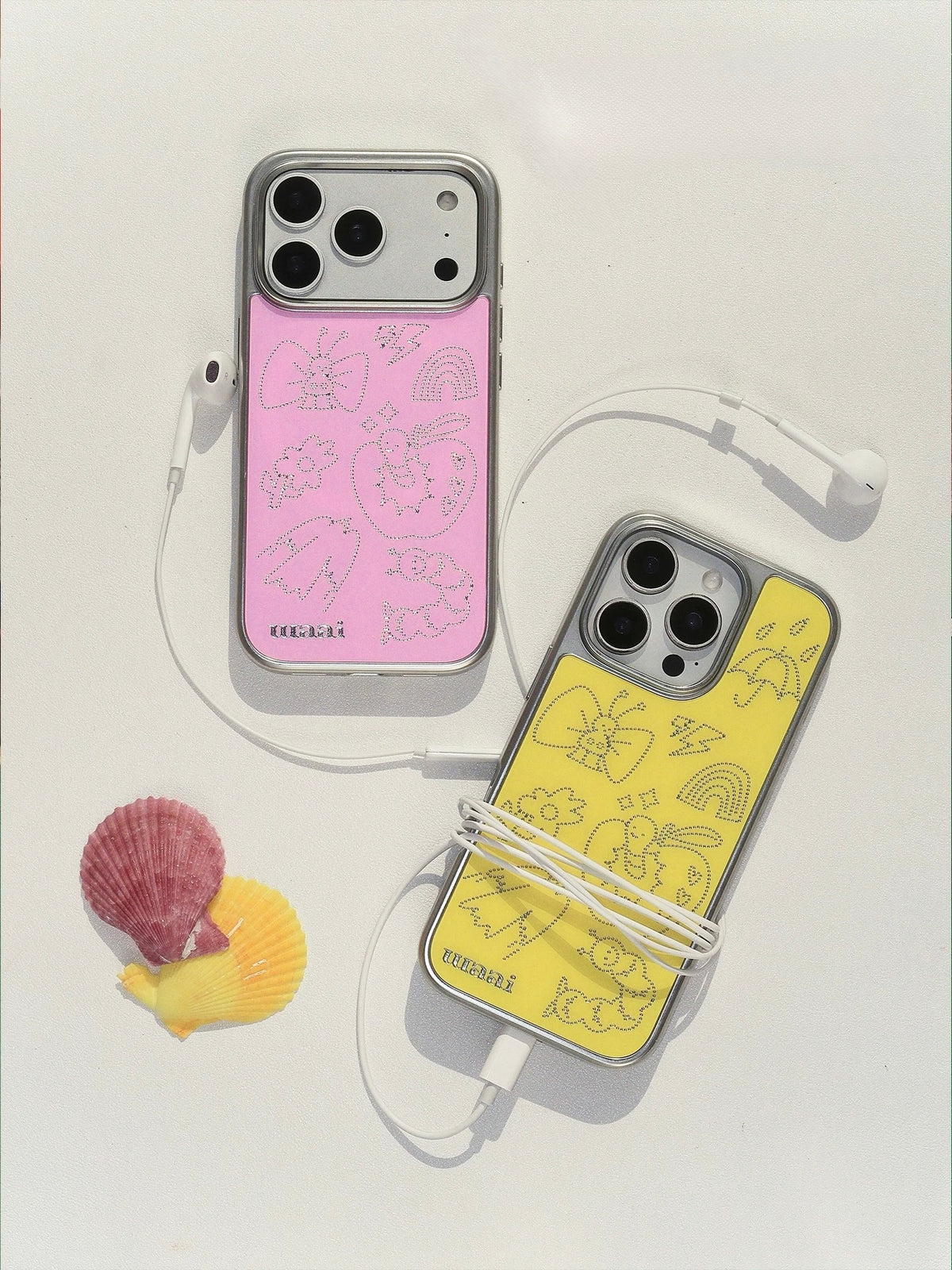 Pink and lemon yellow doodle phone case options shown together, with the pink case above the yellow one.