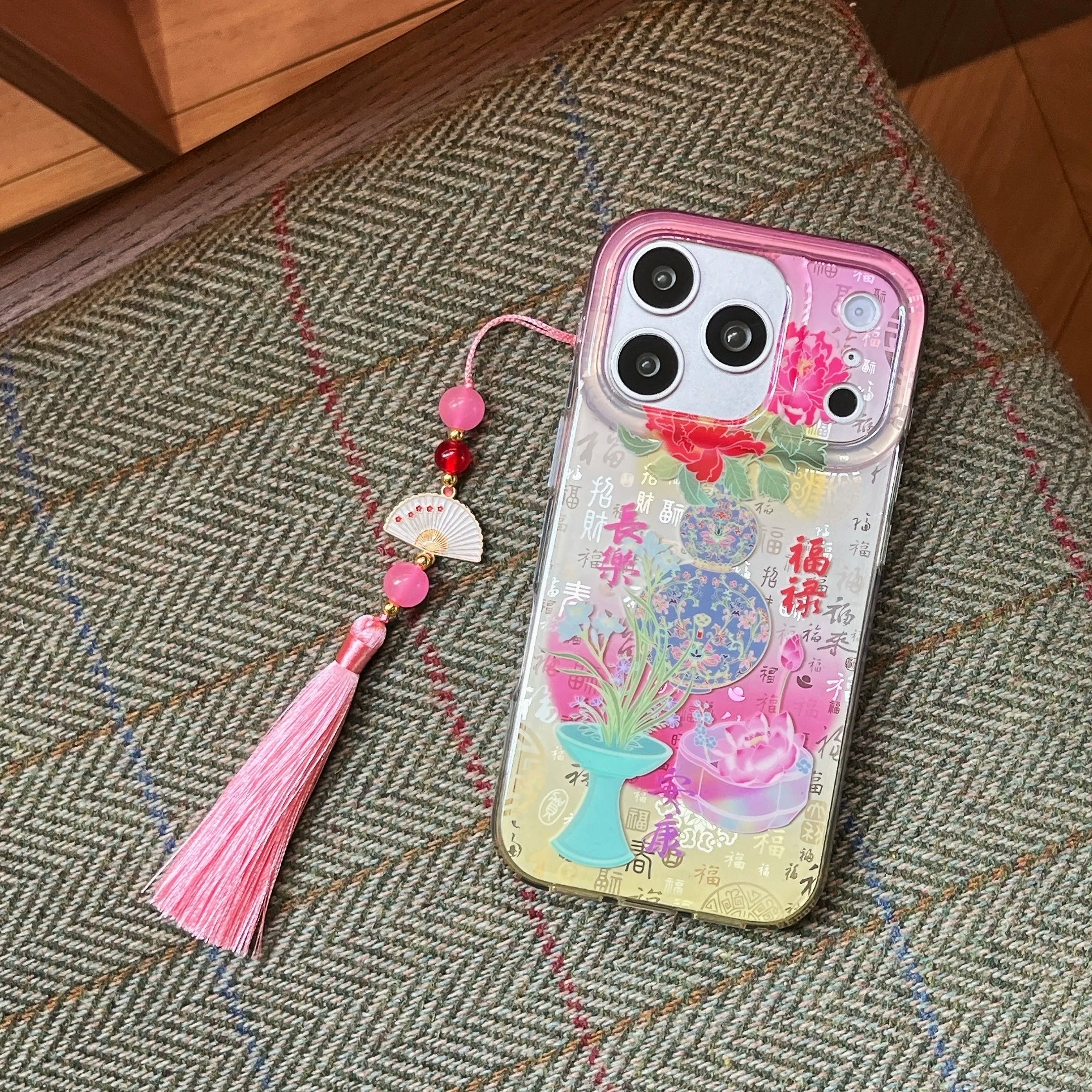 Pink Chinoiserie silicone iPhone case featuring blooming peonies decorative porcelain artwork and optional tassel charm
