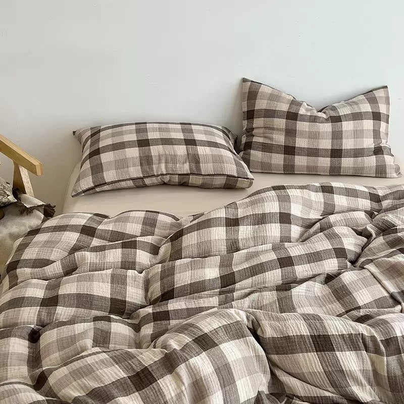 Brown check duvet cover set styled on a bed with a solid cognac accent pillowcase