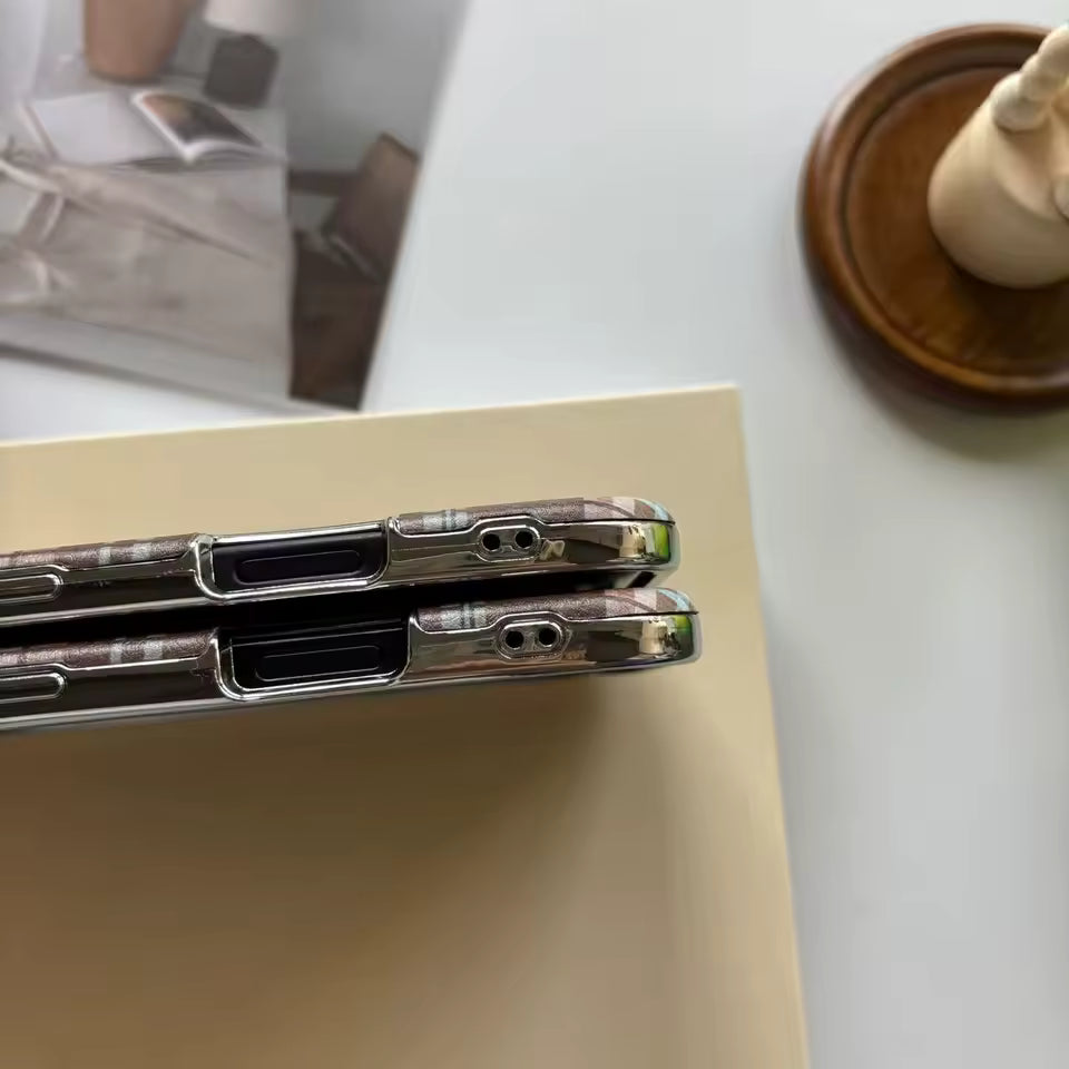 Two phone cases on a light surface with a blurred background