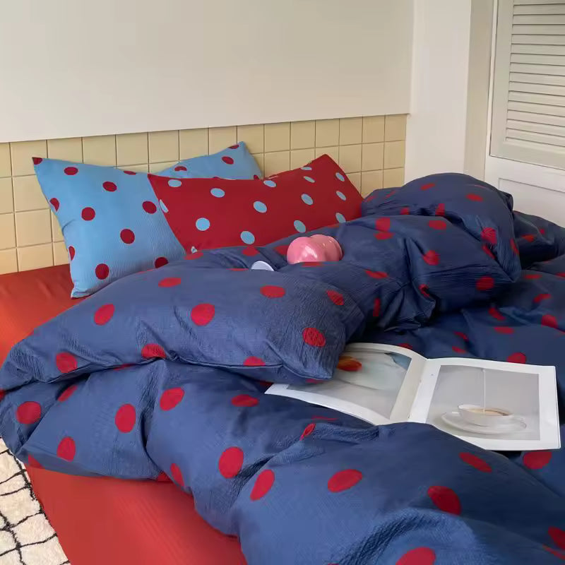 Blue and red polka dot duvet cover styled for playful teen bedroom decor cozy aesthetic