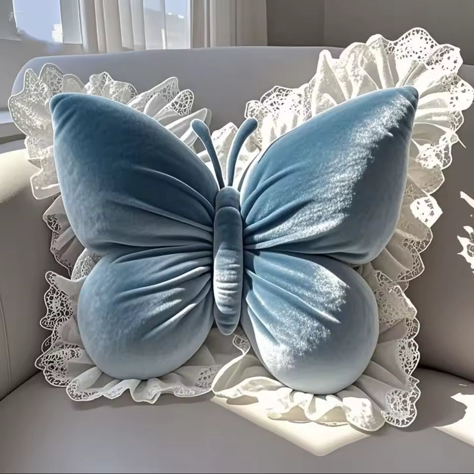 Blue butterfly-shaped pillow on a decorative background