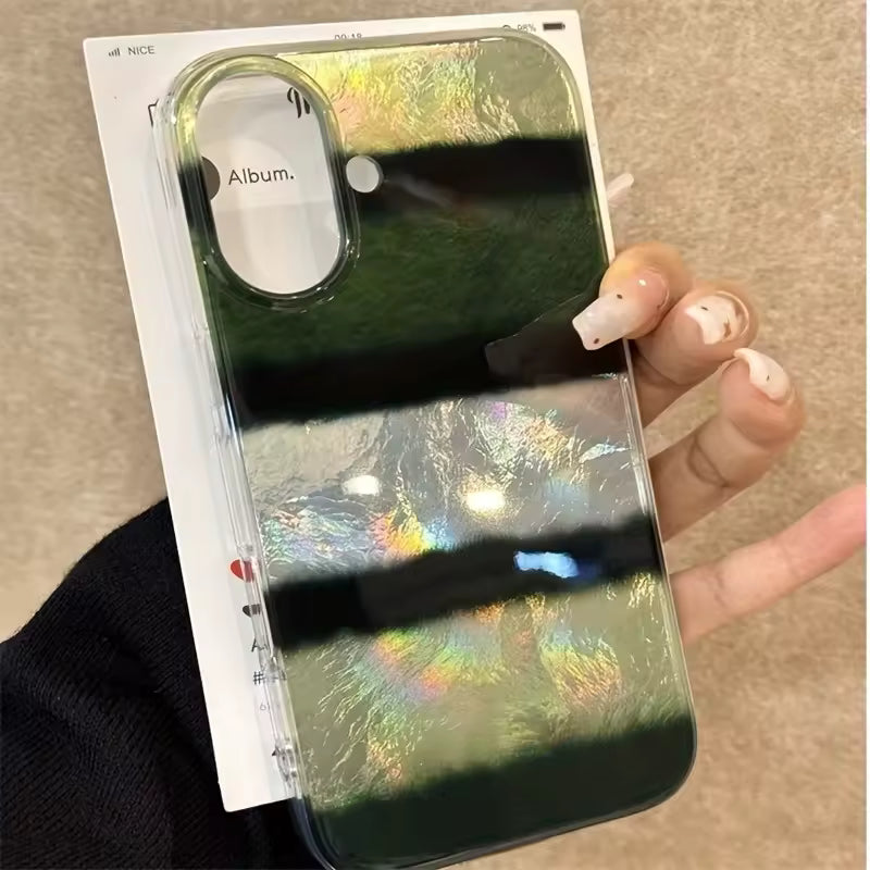 Phone case with reflective surface held by a hand on a neutral background