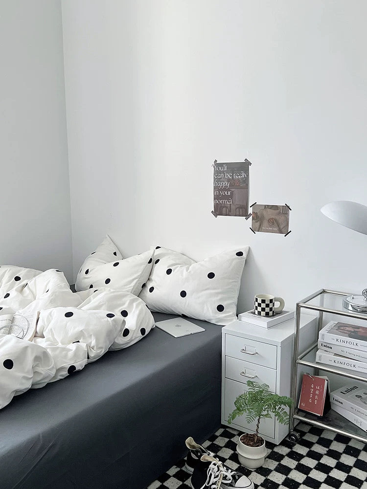 Small bedroom with a bed, nightstand, and bookshelf.