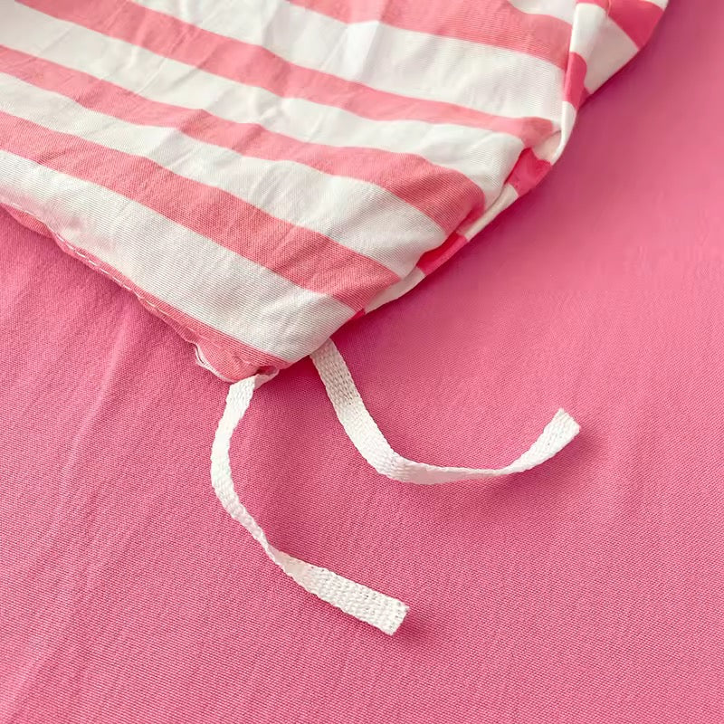 Pink and white striped fabric on a pink background