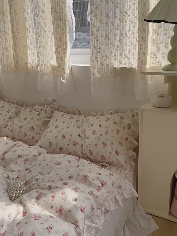 Soft girl bedroom styled with delicate pink floral duvet and fairy curtains