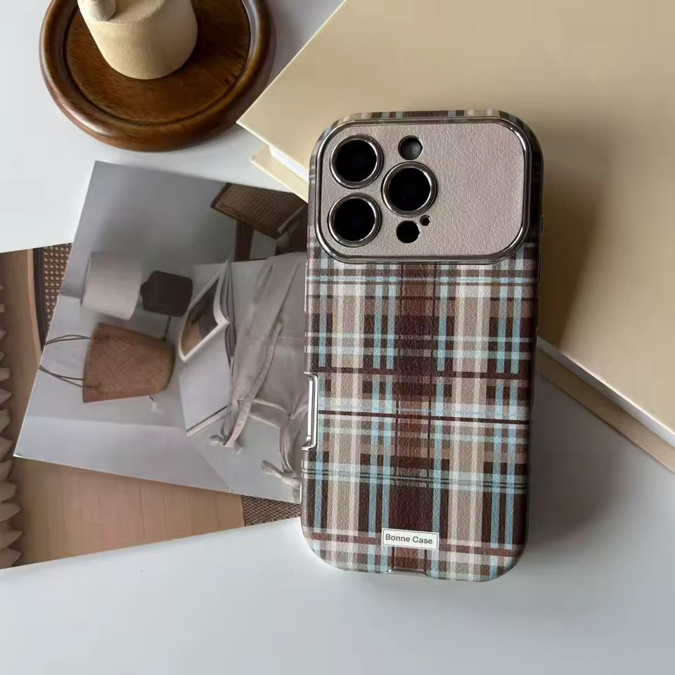 Plaid patterned phone case on a surface with a blurred background