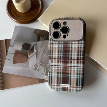 Plaid patterned phone case on a surface with a blurred background