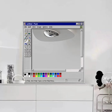 Computer screen displaying a paint software interface on a white wall.