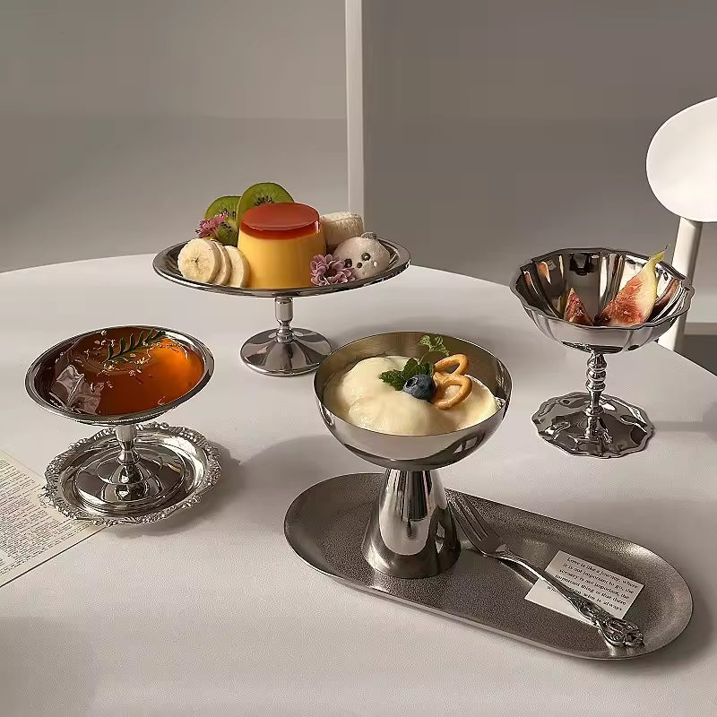 Silver dessert platter with various small dishes of desserts on a white surface.