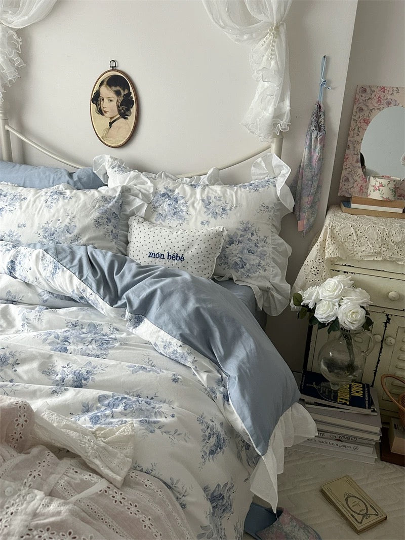 Coquette-inspired room decor featuring a blue floral lace duvet cover set.