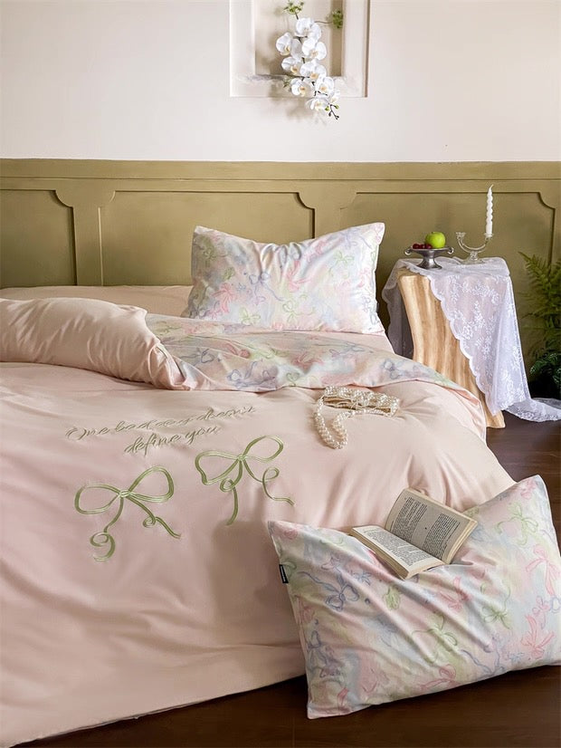 Floral bedding set on a bed with a decorative pillow and book in a bedroom setting.
