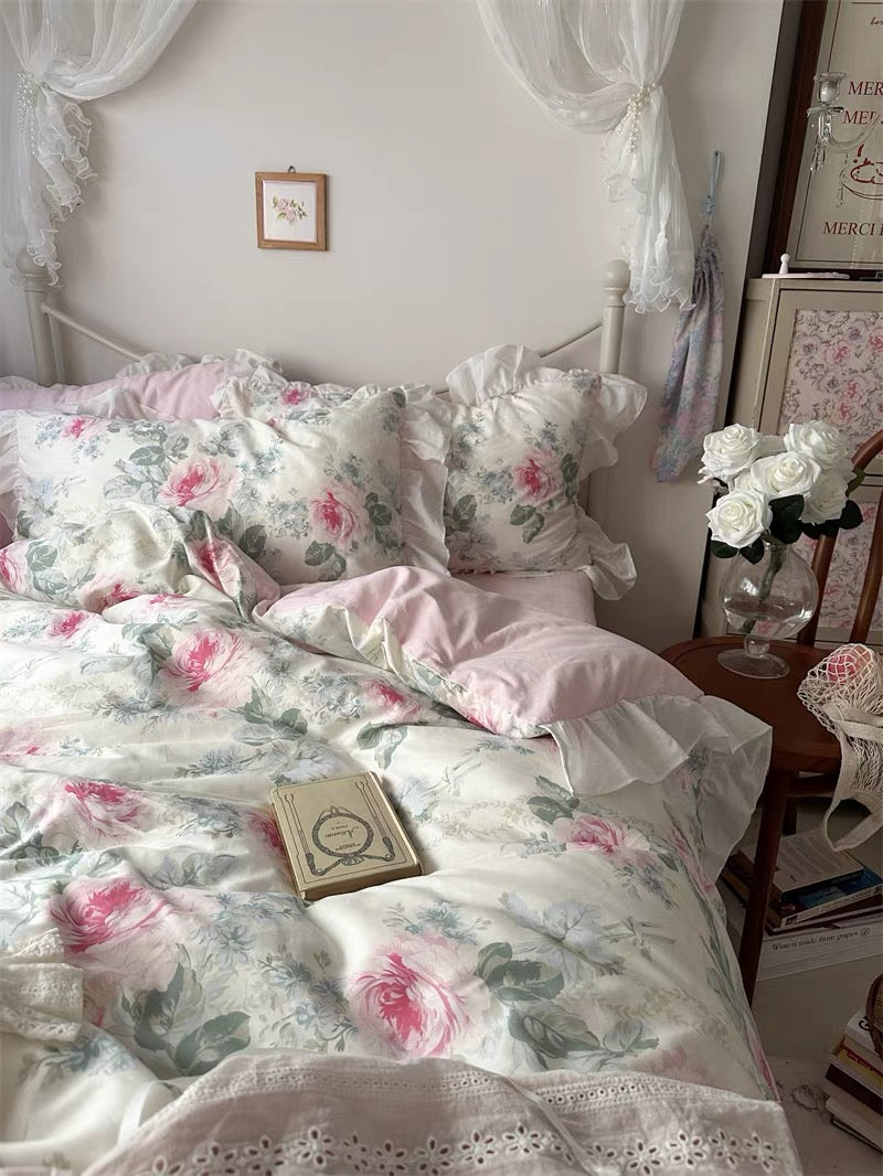 Romantic rose duvet cover in pastel pink cotton with delicate frills on the bed.