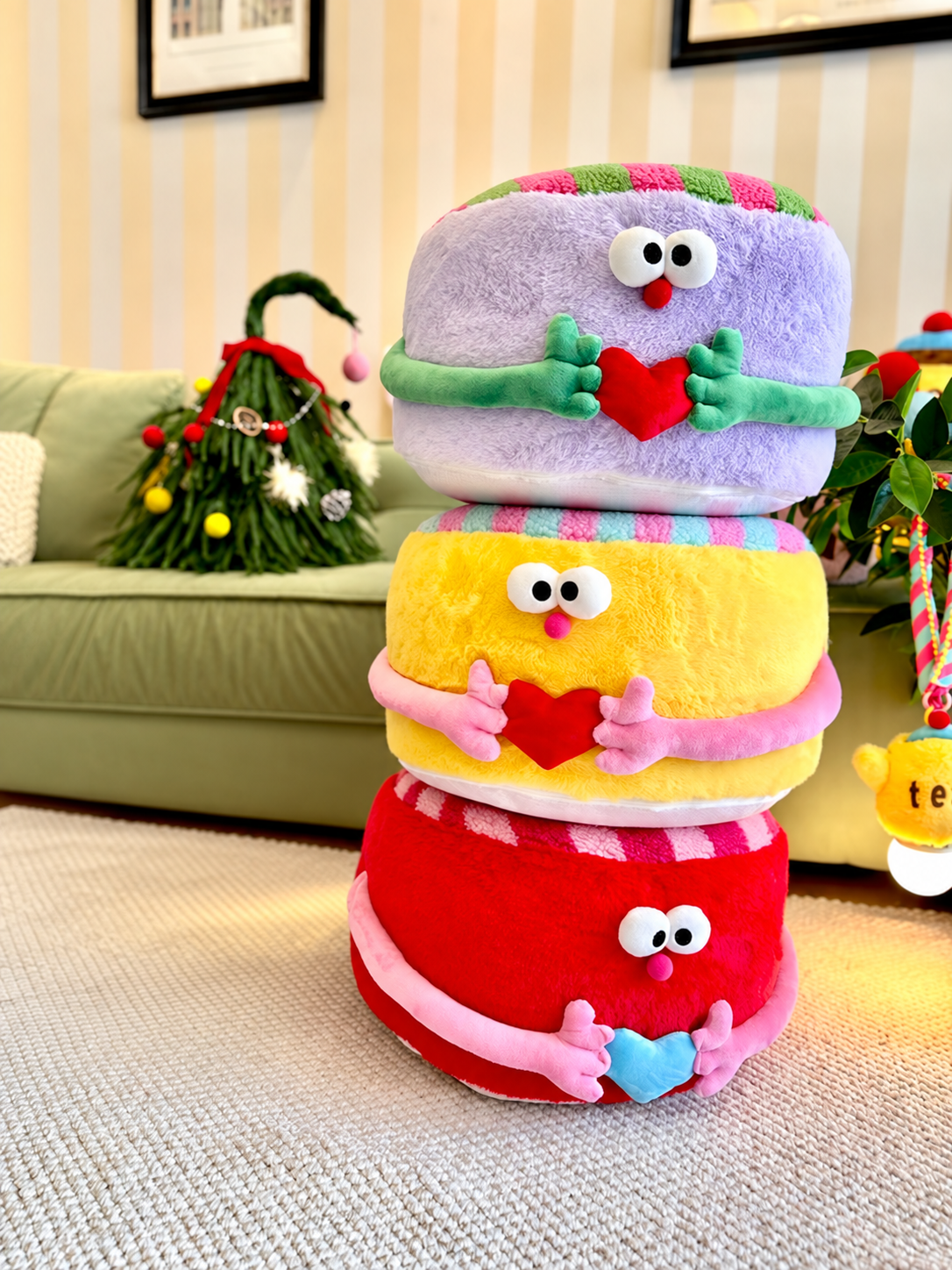 Colorful striped ottoman poufs in red, purple, and yellow with heart details