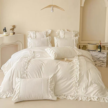 Neatly made bed with white bedding in a bedroom setting.