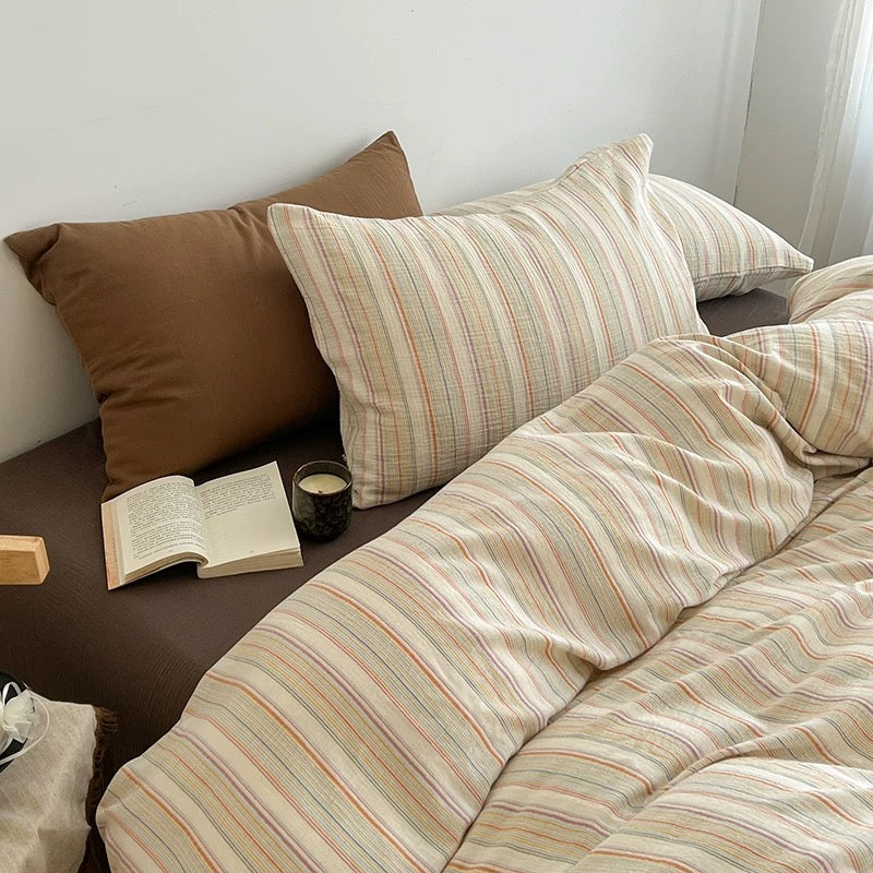 Vintage stripe bedding set paired with a mocha brown pillowcase in a warm neutral bedroom
