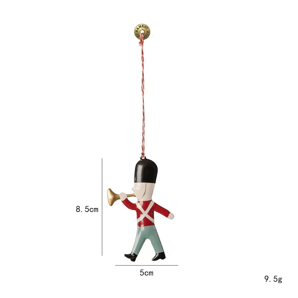 Scandinavian Christmas ornaments include a red jacketed soldier with a black hat and gold trumpet.