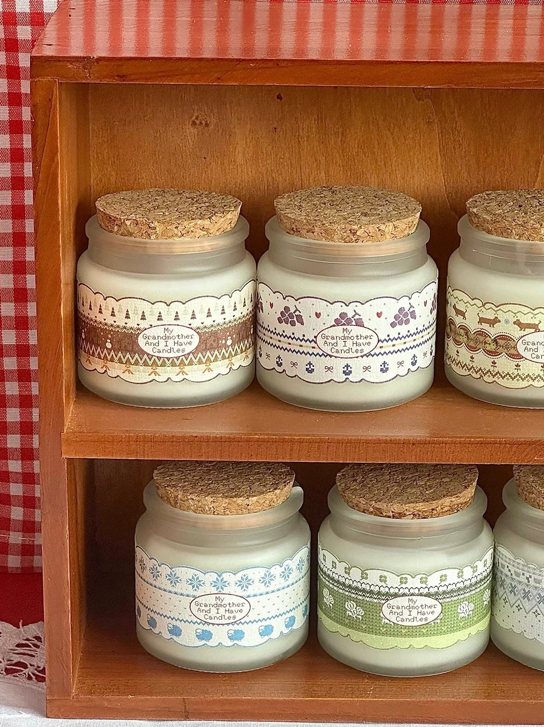 Glass jar scented candles displayed together on a shelf